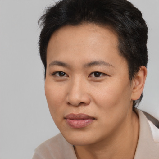Joyful asian young-adult female with short  brown hair and brown eyes