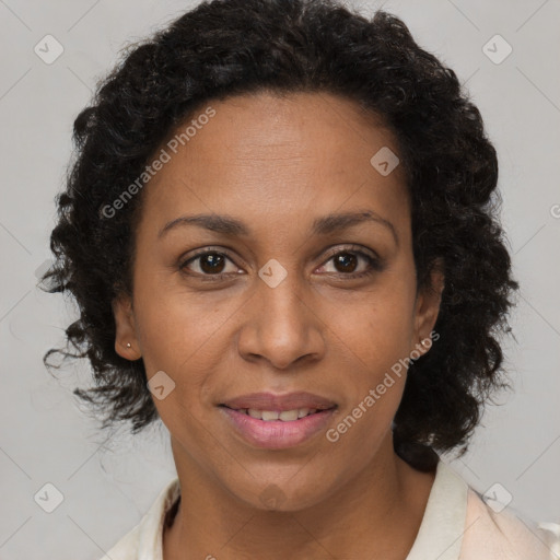 Joyful black adult female with short  brown hair and brown eyes