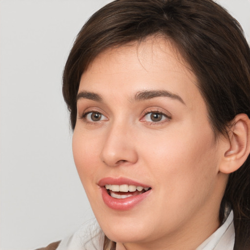 Joyful white young-adult female with medium  brown hair and brown eyes