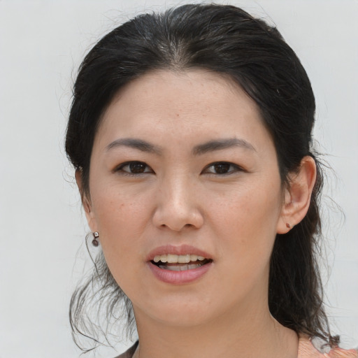 Joyful asian young-adult female with medium  brown hair and brown eyes