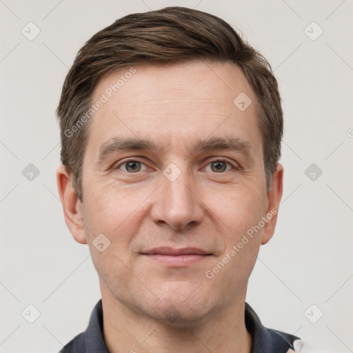 Joyful white adult male with short  brown hair and grey eyes