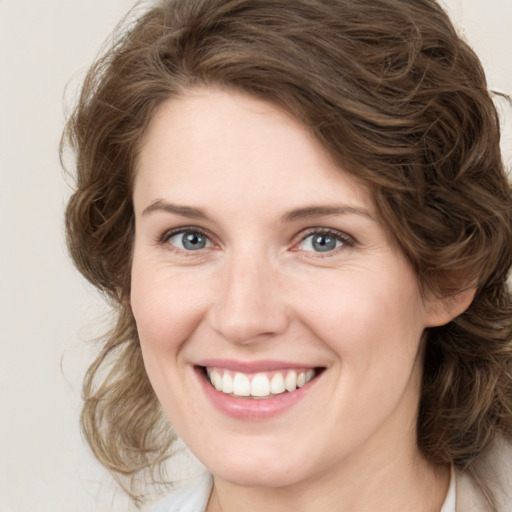 Joyful white young-adult female with medium  brown hair and green eyes