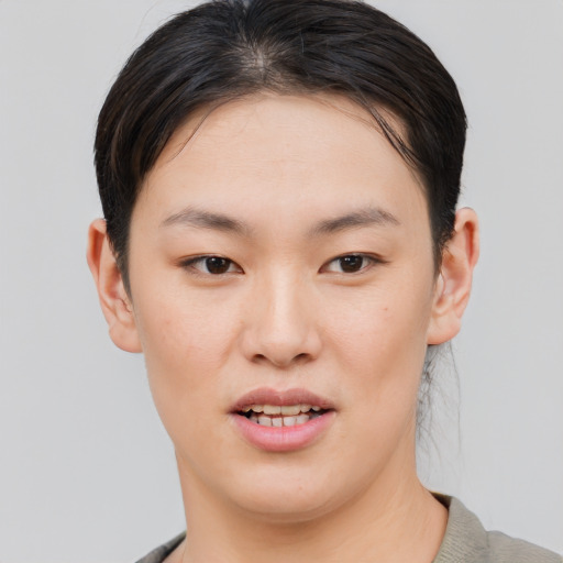 Joyful asian young-adult female with short  brown hair and brown eyes