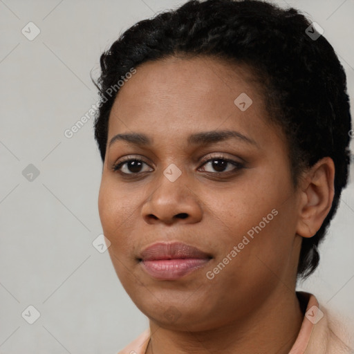 Joyful black young-adult female with short  black hair and brown eyes