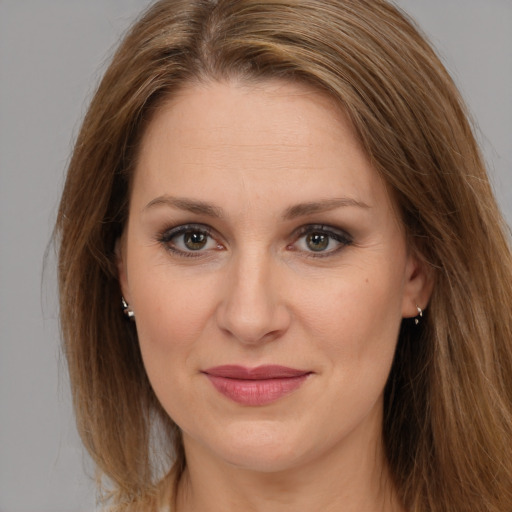 Joyful white young-adult female with long  brown hair and brown eyes