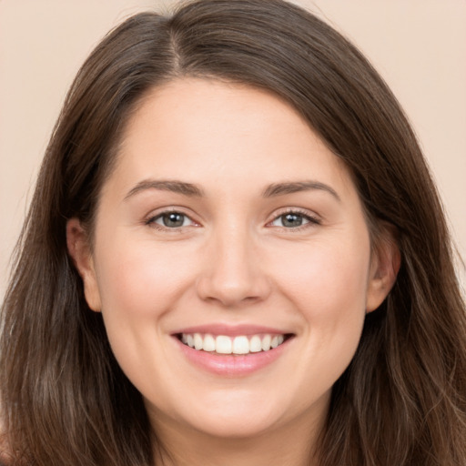 Joyful white young-adult female with long  brown hair and brown eyes