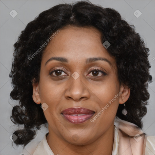 Joyful black adult female with medium  brown hair and brown eyes