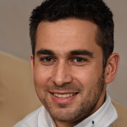 Joyful white young-adult male with short  brown hair and brown eyes