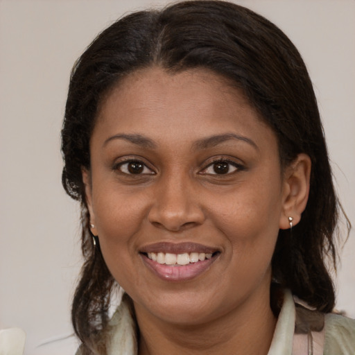 Joyful latino young-adult female with medium  brown hair and brown eyes