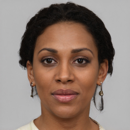 Joyful black young-adult female with short  brown hair and brown eyes