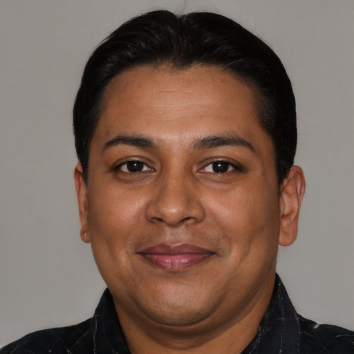 Joyful asian adult male with short  black hair and brown eyes