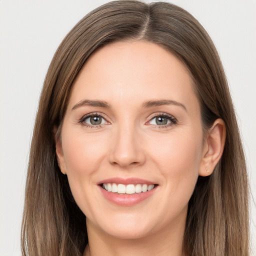 Joyful white young-adult female with long  brown hair and grey eyes