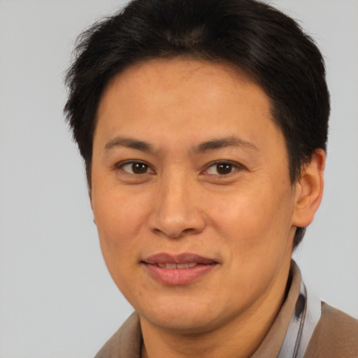 Joyful asian adult female with short  brown hair and brown eyes