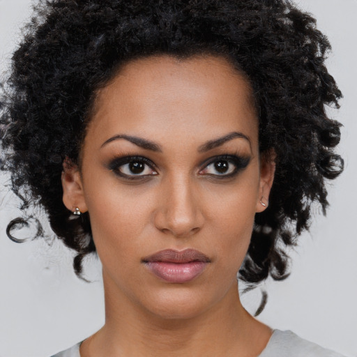 Neutral black young-adult female with medium  brown hair and brown eyes