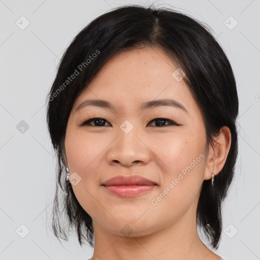 Joyful asian young-adult female with medium  black hair and brown eyes