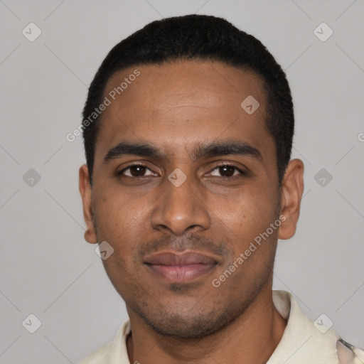 Joyful black young-adult male with short  black hair and brown eyes