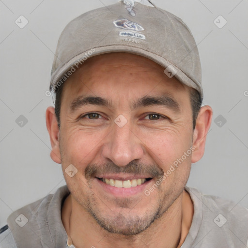 Joyful white adult male with short  black hair and brown eyes