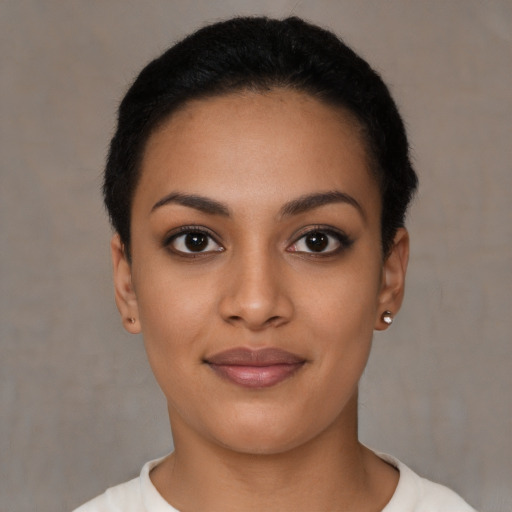 Joyful latino young-adult female with short  black hair and brown eyes