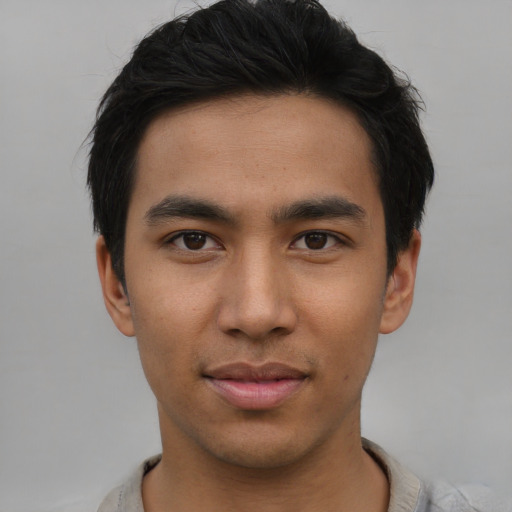 Joyful asian young-adult male with short  black hair and brown eyes