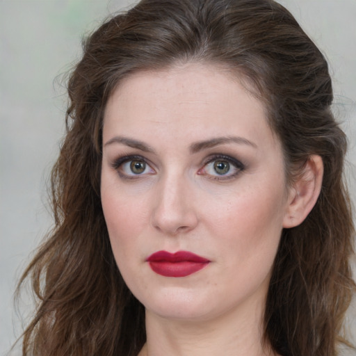 Joyful white young-adult female with medium  brown hair and green eyes