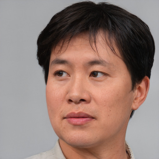 Neutral asian adult male with short  brown hair and brown eyes