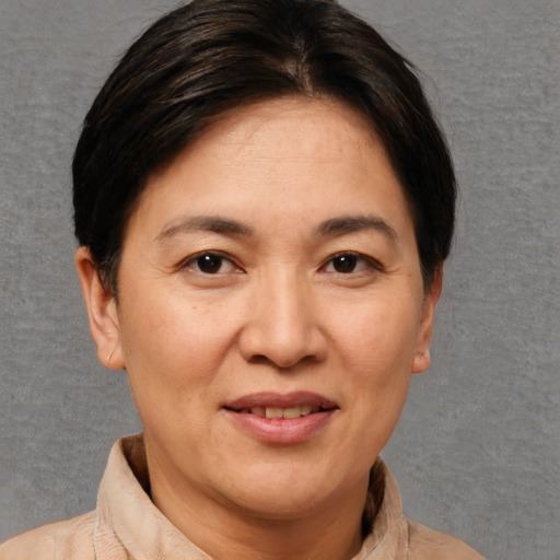 Joyful white adult female with short  brown hair and brown eyes