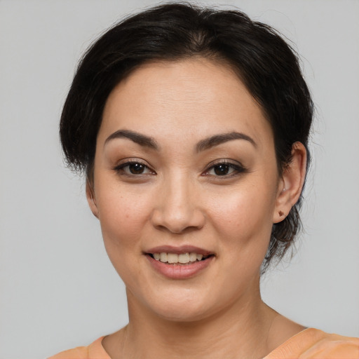 Joyful asian young-adult female with medium  brown hair and brown eyes