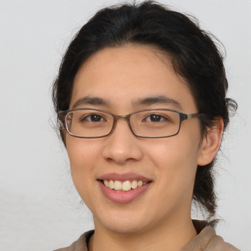 Joyful white young-adult female with medium  brown hair and brown eyes