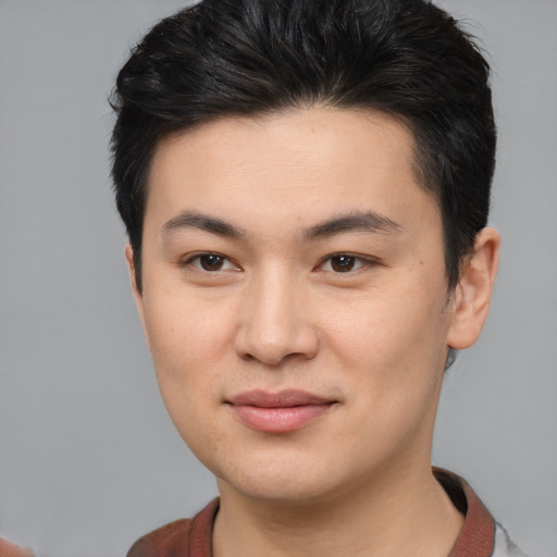 Joyful asian young-adult male with short  brown hair and brown eyes