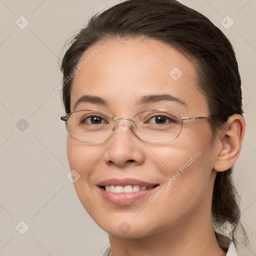 Joyful white adult female with medium  brown hair and brown eyes