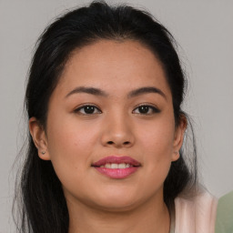 Joyful latino young-adult female with medium  brown hair and brown eyes