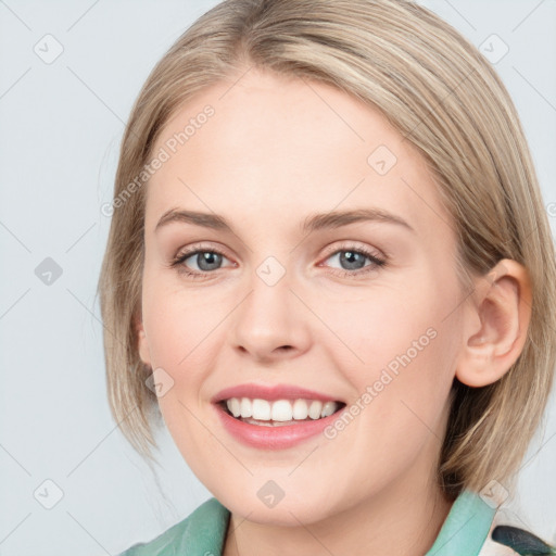 Joyful white young-adult female with medium  brown hair and blue eyes