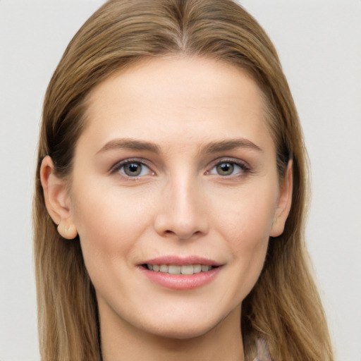 Joyful white young-adult female with long  brown hair and grey eyes