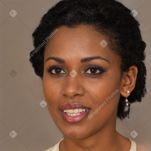 Joyful black young-adult female with short  black hair and brown eyes