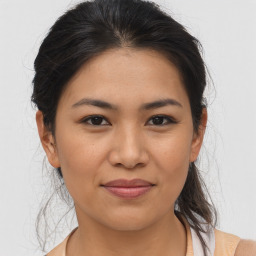 Joyful asian young-adult female with medium  brown hair and brown eyes