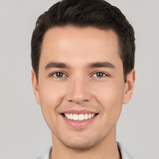 Joyful white young-adult male with short  brown hair and brown eyes