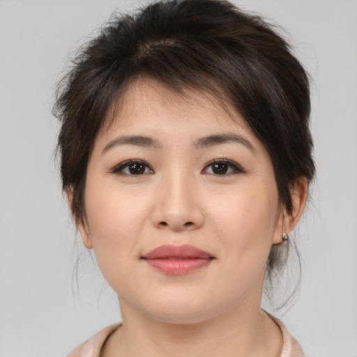 Joyful asian young-adult female with medium  brown hair and brown eyes