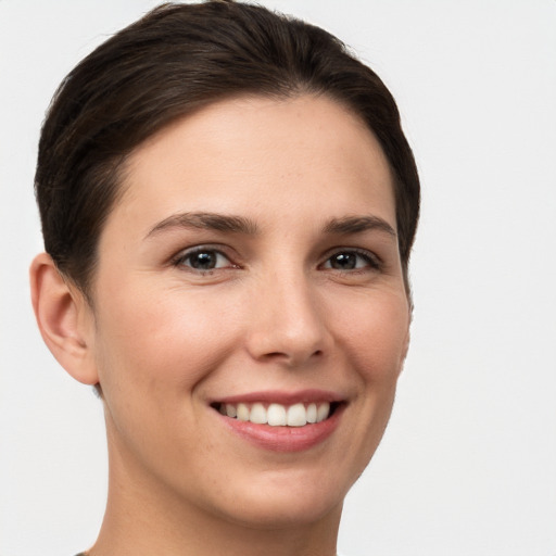 Joyful white young-adult female with short  brown hair and brown eyes