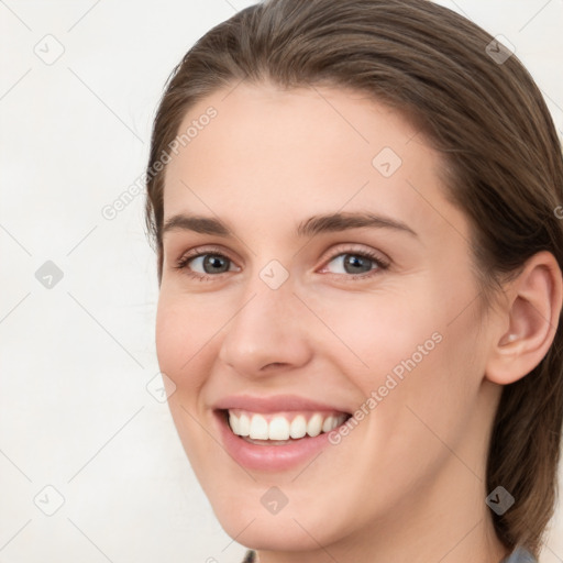 Joyful white young-adult female with medium  brown hair and grey eyes