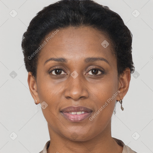 Joyful black adult female with short  brown hair and brown eyes