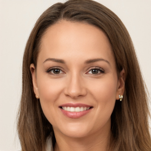 Joyful white young-adult female with long  brown hair and brown eyes