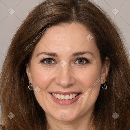 Joyful white adult female with long  brown hair and brown eyes