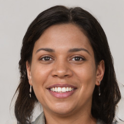 Joyful white adult female with medium  brown hair and brown eyes