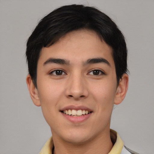 Joyful white young-adult male with short  black hair and brown eyes