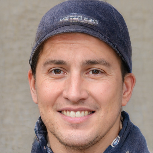 Joyful white adult male with short  brown hair and brown eyes