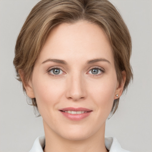 Joyful white young-adult female with medium  brown hair and grey eyes