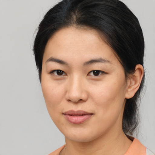 Joyful asian young-adult female with medium  brown hair and brown eyes