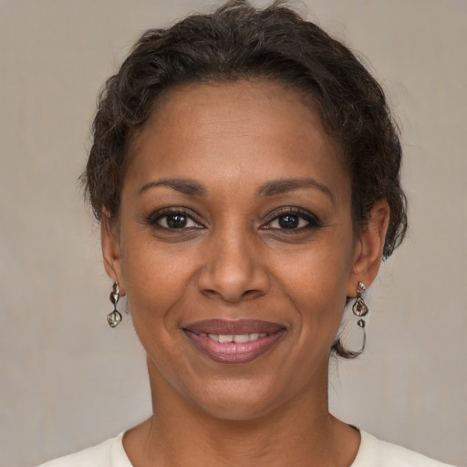 Joyful black adult female with short  brown hair and brown eyes
