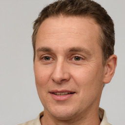 Joyful white adult male with short  brown hair and brown eyes