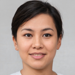 Joyful asian young-adult female with short  brown hair and brown eyes